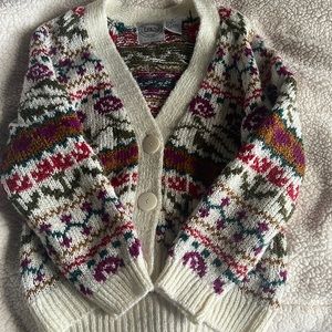 Colorful cardigan sweater with rose pattern.